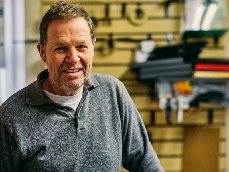 Professional handyman from The Best Handymans LLC in workshop with tools and materials